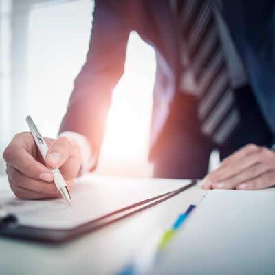 man signing a document - buying real estate