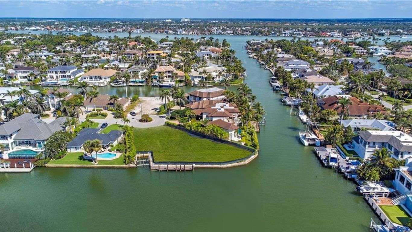Waterfront canal homes with private docks and boats showcasing a relaxed boating lifestyle.